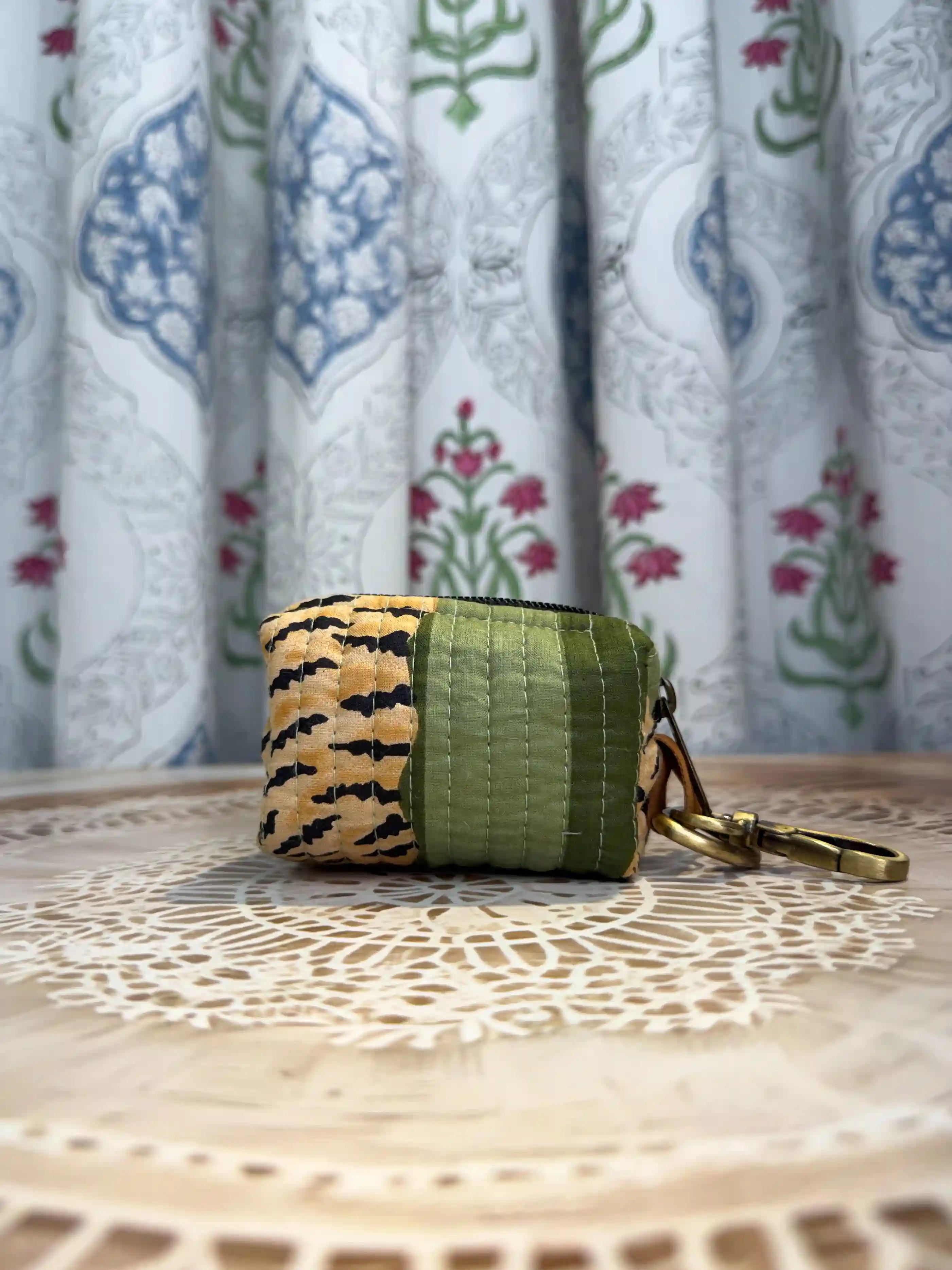 Trending tiger print green quilted cotton keychain pouch with yellow and black hand block tiger stripes, features durable zipper and brass keyring for keys and coins.
