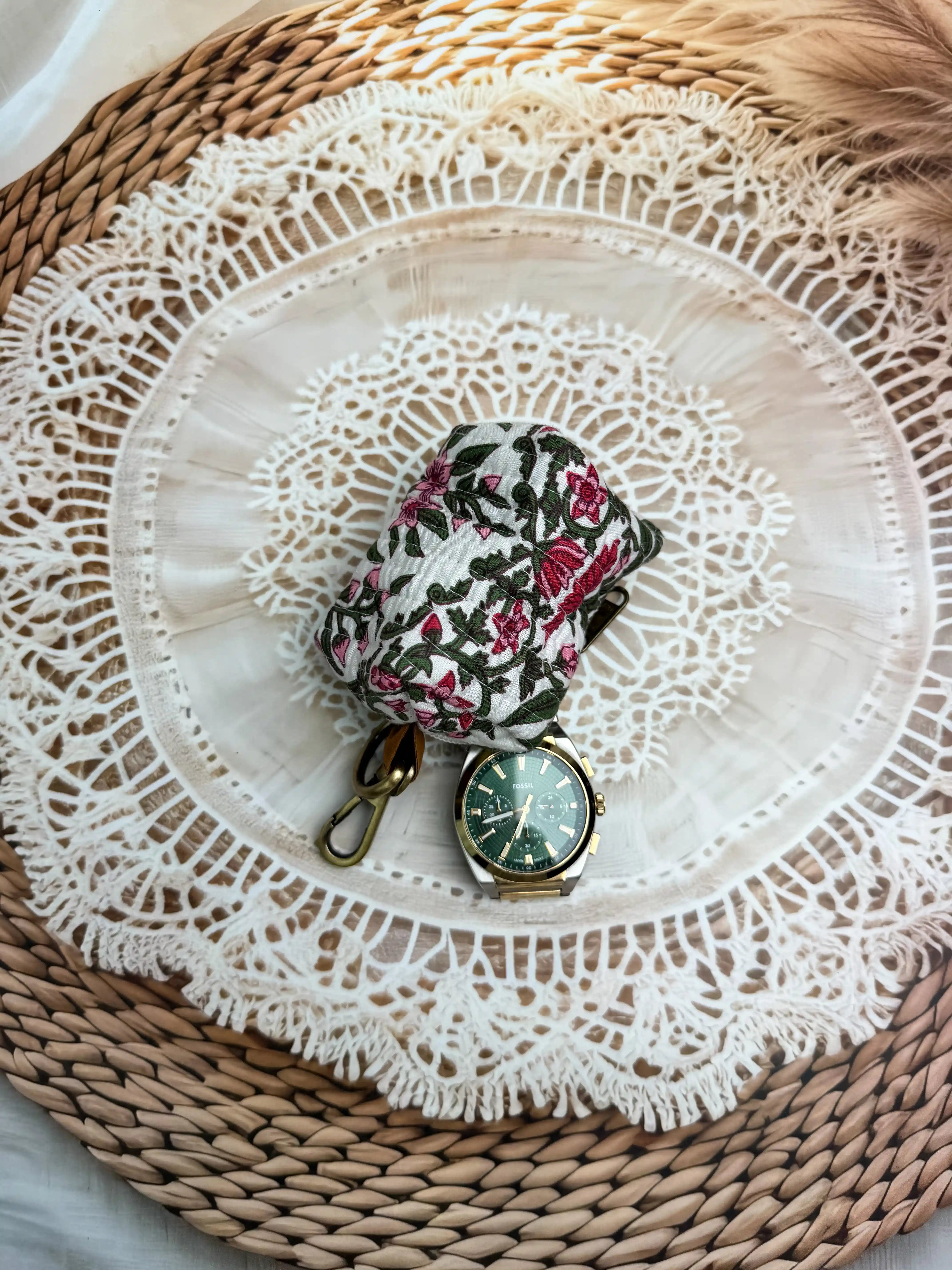 white quilted cotton keychain pouch with hand block printed red and green botanical floral design, durable zipper with metal keyring for carrying coins and essentials