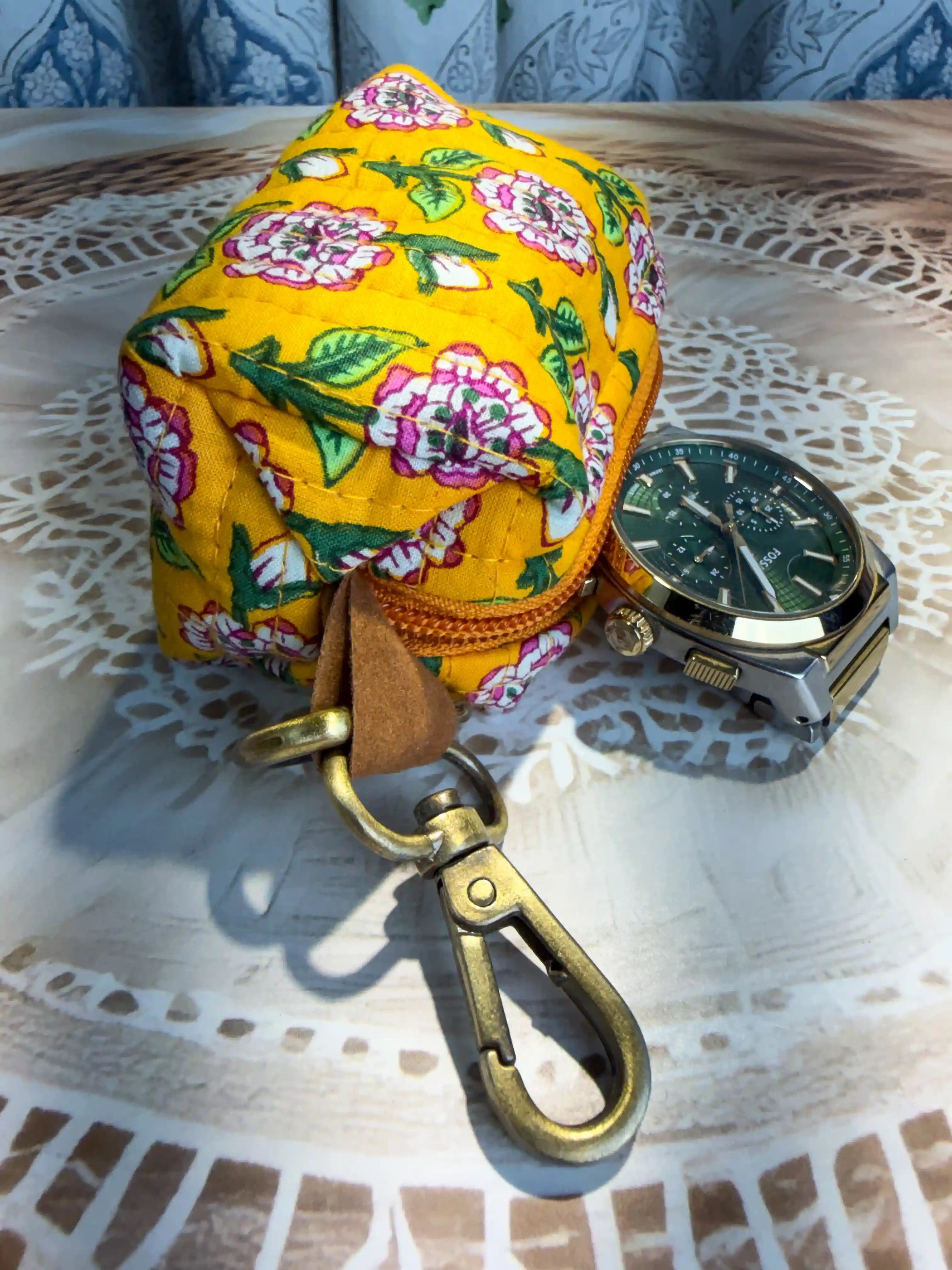 Yellow quilted cotton keychain pouch with hand block printed green geometric and floral elements, includes zip closure and keyring for organizing keys and small items